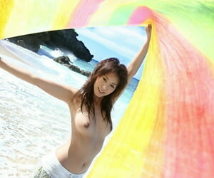 Sexy Japanese teen Honoka exposes nice tits and bush during a day at the beach