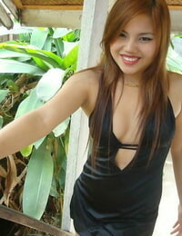 Filipino model in a ebon clothing shows her uncovered legs during modeling non unclothed