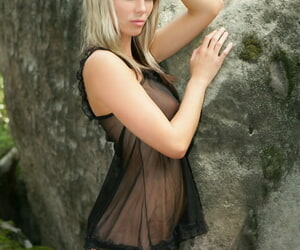 Hot blonde model Gina lets her see thru lingerie fall aside among the rocks