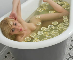 Cute peaches teen sinks her bald twat into a tub filled roughly lemon slices