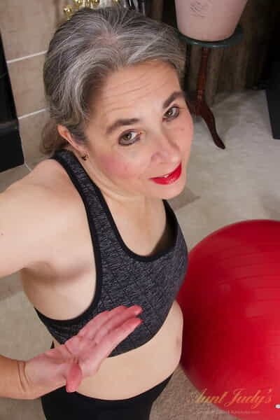 Mature granny Grace doffs her fitness outfit and touches her bushy twat