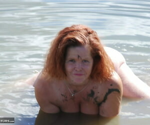 Redheaded amateur Misha covers her big interior in orts while in shallow water