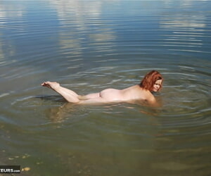 Redheaded amateur Misha covers her big interior in orts while in shallow water