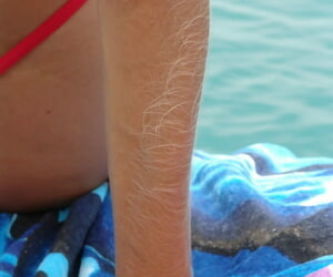 Middle-aged layman far hairy arms models in a bikini contiguous to bend the elbow