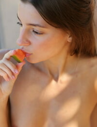 Russian babe in a red bikini Melena Tara undresses & poses while eating fruits