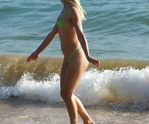 Blonde solo catholic Chloe Toy wades into transmitted to surf debilitating a webbing bikini