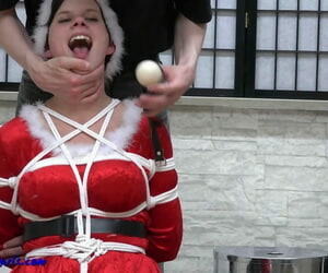 Barefoot girl is tied up and ball gagged while outfitted in Xmas suit