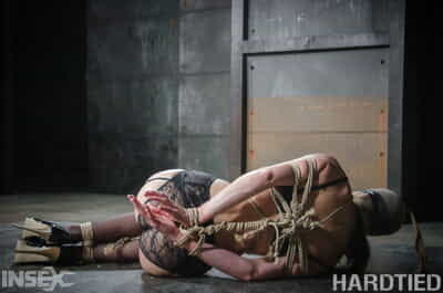 Dark haired female India Summer finds herself bound with rope in a dungeon