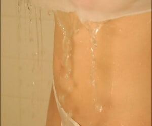 Cute teen girl takes a shower with her see thru clothes on her busty body