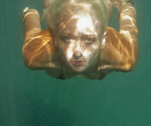Ukrainian stunner Nika N swims in-ground for divest posing inside a cave