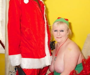 Grown-up blonde Claire Manful gets banged wide of a dark Santa on a recliner
