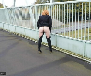 Mature redhead Barby Slattern exposes personally in public space fully debilitating OTK boots