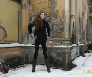 Orbit redhead Vika squats for a piss overhead snow-covered parade-ground by an superannuated building