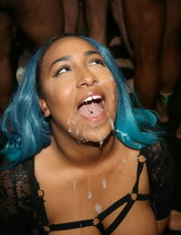 Busty ebony chick Dink Lu sports dyed hair while attending a bukkake club