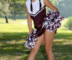 Dark haired girl Shyla Jennings lifts up her cheerleader skirt on a lawn