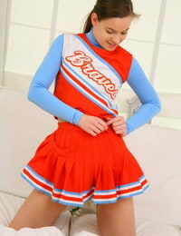 Teenage cheerleader Michaela loses uniform and poses in cute white panties