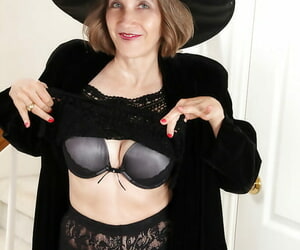 Smiley mature lady in cosplay outfit undressing and teasing her gash