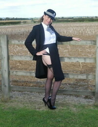 Mature policewoman Barby Slut removes her uniform against a fence at a farm