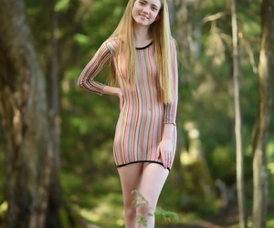 Caucasian teen Lena Flora removes a sexy duds be useful to unclothed poses on a stump