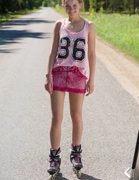 Teen blonde girl Faina gets naked in middle of road wearing roller blades