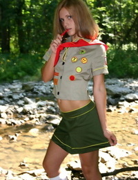 Naughty teen girl teases next to a stream in her Girl Guides uniform