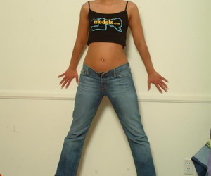 Short haired girl Gia models non nude in cropped shirt and denim jeans