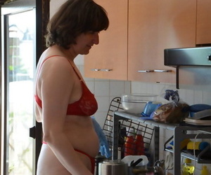 Leggy woman does her housework in bra and thong with matching heels