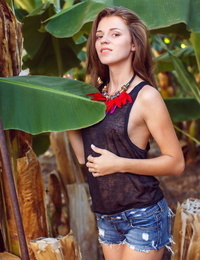 Clothed solo girl in denim shorts revealing flat teen chest outdoors