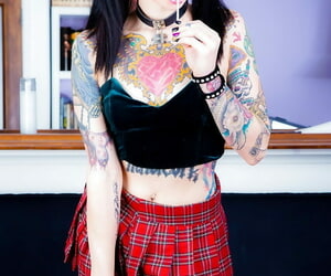 Tattooed Necro Nicki in pigtails & short skirt on knees showing tight ass