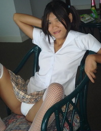 Nice-looking Oriental adolescent shows off her skinhead cum-hole in mesh nylons and pigtails