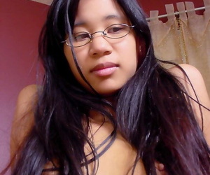 Asian first timer oils up her shaved pussy with her glasses overhead