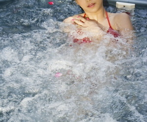 Young Japanese girl tales lacking her bikini near an outdoor hot gargle