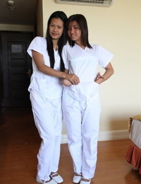 Lusty filipina nurses Joanna and Pleasure pose on the bed in their white uniforms