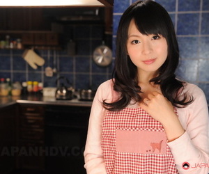 Japanese housewife with a pretty face poses non nude in her kitchen