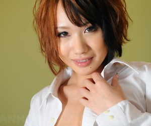Japanese model Luna covers her breasts with hand and forearm in a white blouse