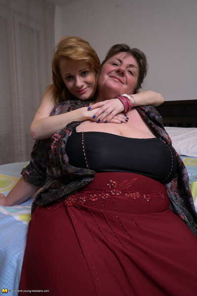Fat mature woman and tiny teen girl engage in lesbian sex acts upon a bed