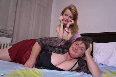 Fat mature woman and tiny teen girl engage in lesbian sex acts upon a bed