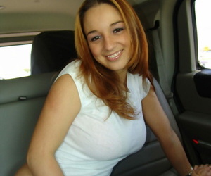 Redhead amateur Nikki Sims pull her T-shirt up and over pink bra in vehicle