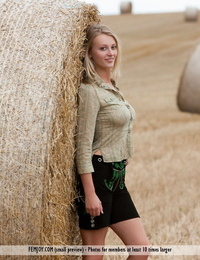 Busty seductive Carisha shows big country girl bazookas & strips in the hay field