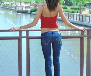 Thin main in crestfallen jeans undressing on touching model barefoot and undressed in public