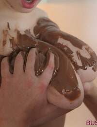 Busty Buffy covers huge tits with chocolate while giving a blowjob