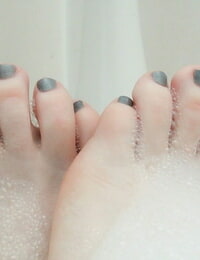 Pale redhead Lucy OHara lathering up her alluring perky tits & toes in the shower-room