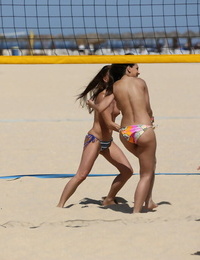 College dears die away topless during a game of beach volleyball