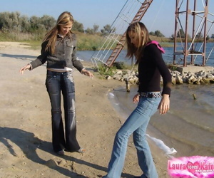 Young girls give denim jeans and jackets convince hands while non unmask within reach the lido