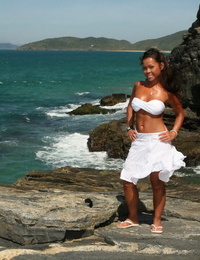 Oriental young makes her stripped modelling debut as the surf pounds the coast bottom