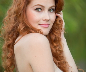 Lord it over sexy redhead Heidi Romanova removes bikini to spread naked outdoors