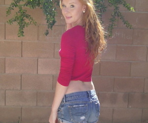 Redhead teen girl Alex Tanner flashes her tiny tits and ass against a wall