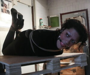 Helpless sub Steffi ball gagged & hog tied fully clothed on a shop forklift