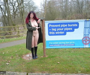 Sexy redhead mature BarbySlut spreading naked outdoors in coat & boots