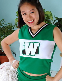Amateur Oriental freeing big tits and ass from beneath cheerleader uniform